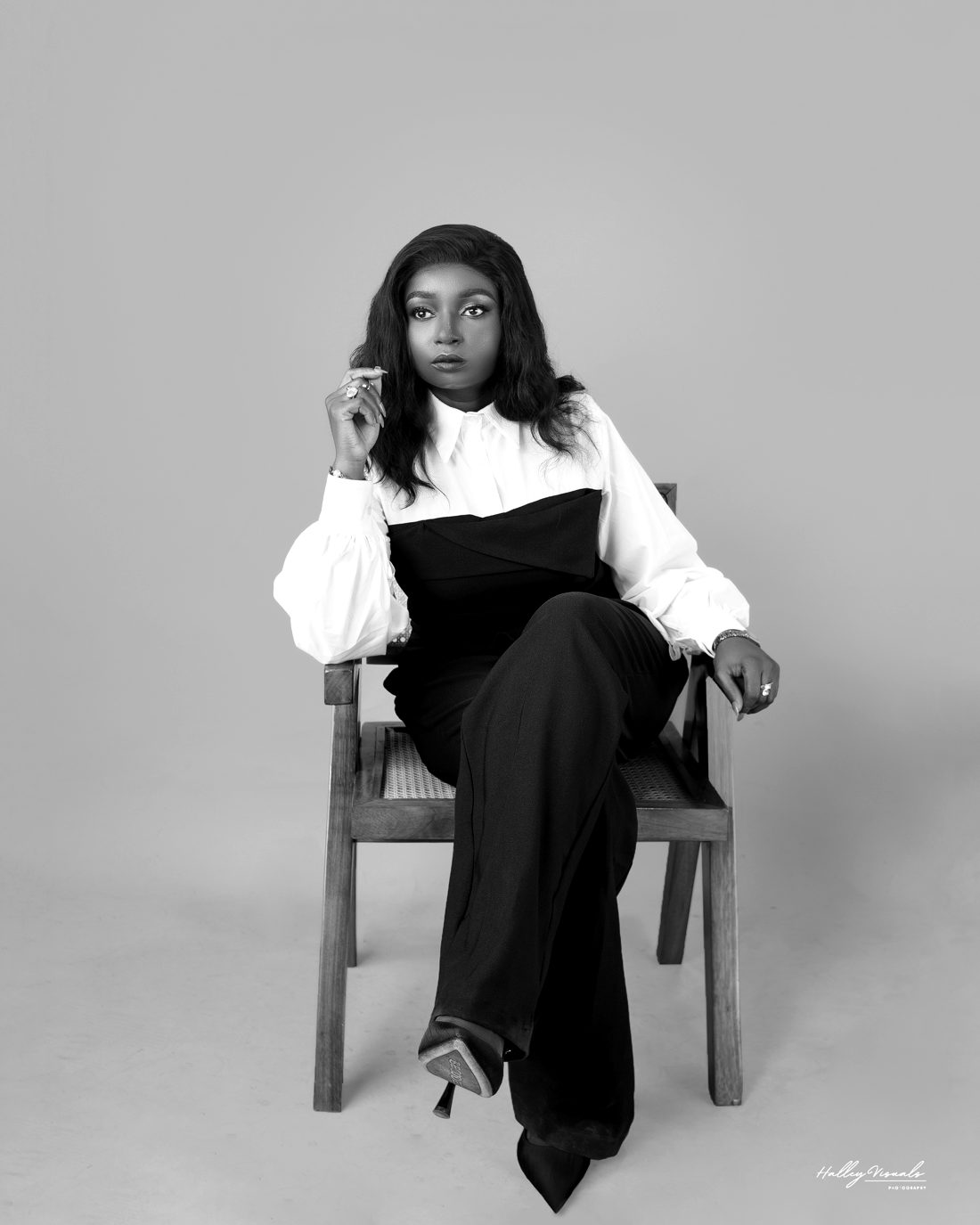Bolanle Akapo seated on a wooden chair