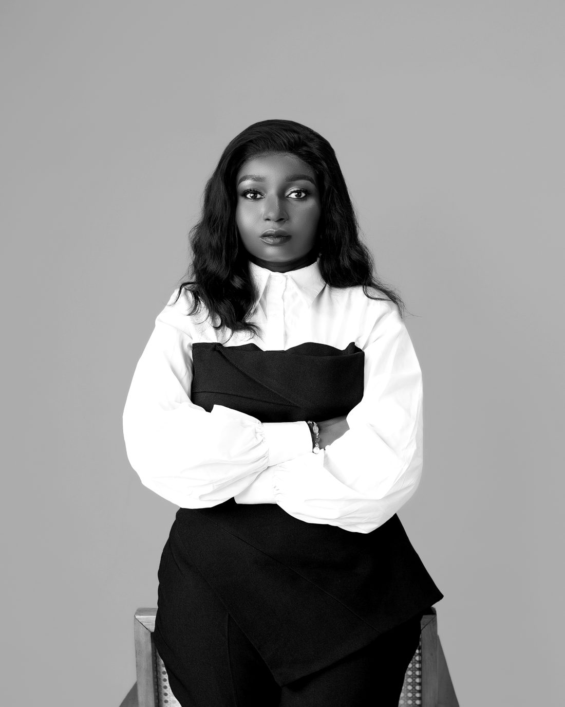 Bolanle Akapo, founder of Sisi Caro, arms folded, in a white shirt and dark top