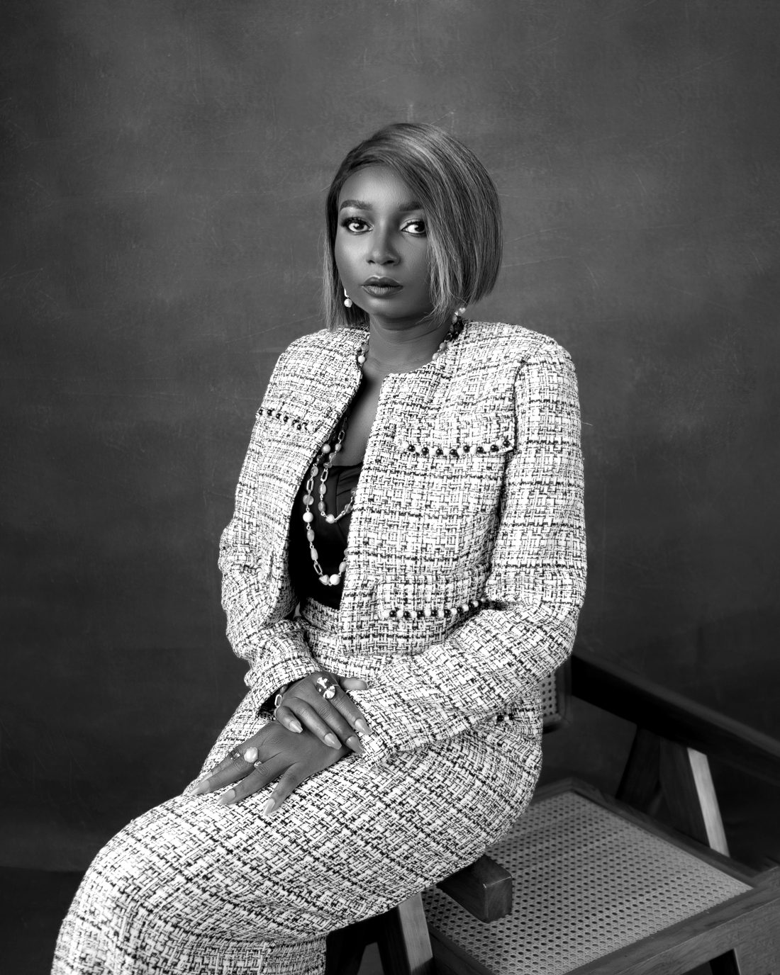 Bolanle Akapo seated in a tweed suit